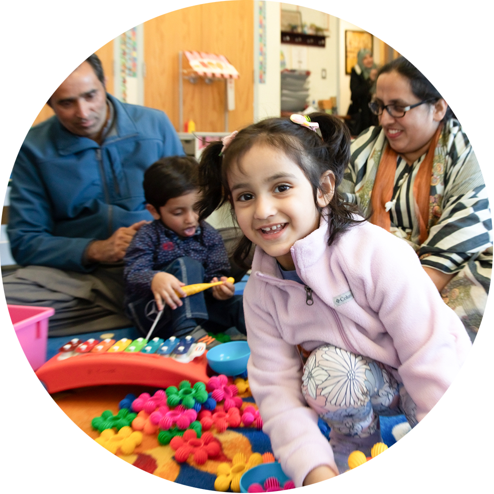 A child smiling while playing with toys