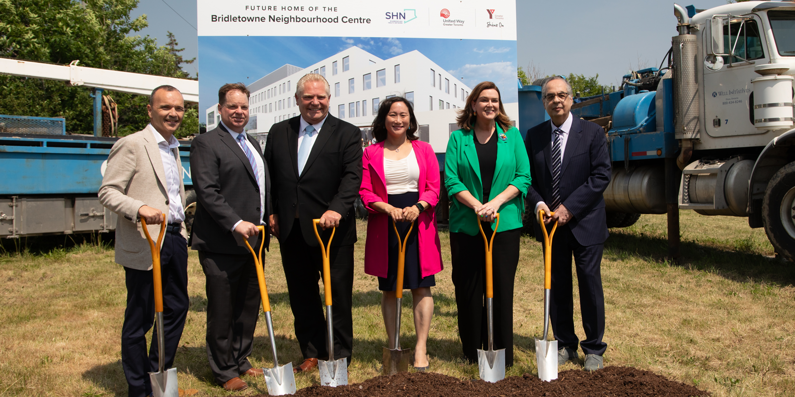 People holding shovels attending a ceremony at the future home of the Bridletowne Neighbourhood Centre