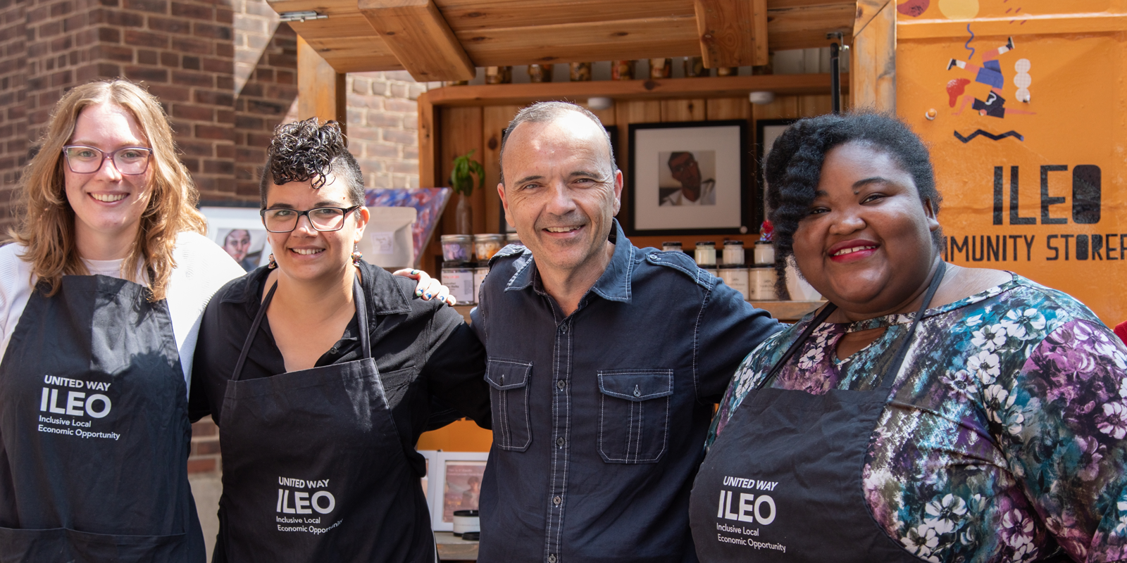 A group of people smiling at ILEO Community Storefront