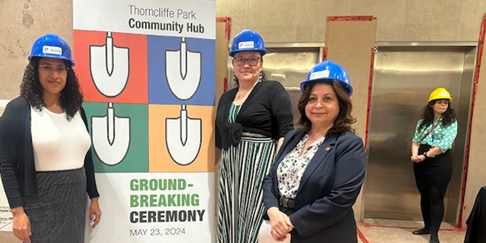 People wearing safety helmets attending the Ground-Breaking ceremony at Thorncliffe Park Community Hub